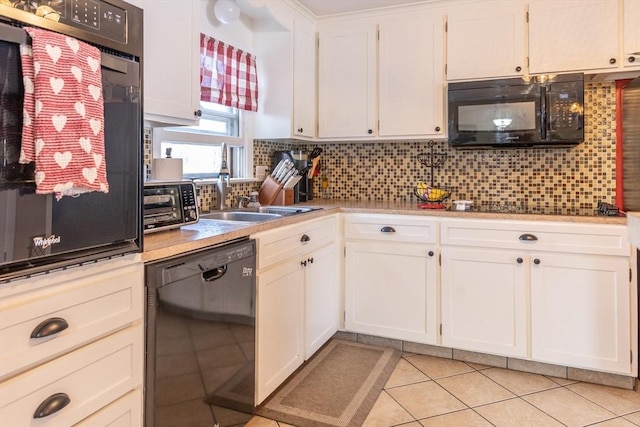 kitchen with white cabinetry, sink, decorative backsplash, and black appliances