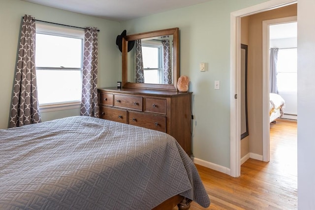 bedroom featuring light hardwood / wood-style floors and baseboard heating