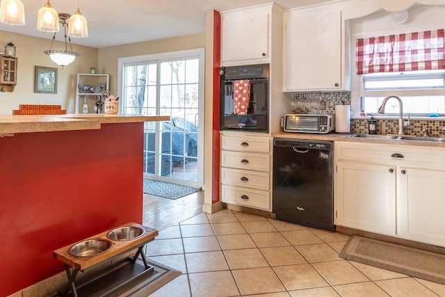 kitchen with pendant lighting, sink, black appliances, and white cabinets