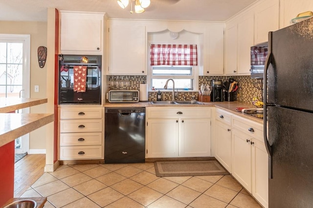 kitchen with sink, a wealth of natural light, white cabinets, and black appliances