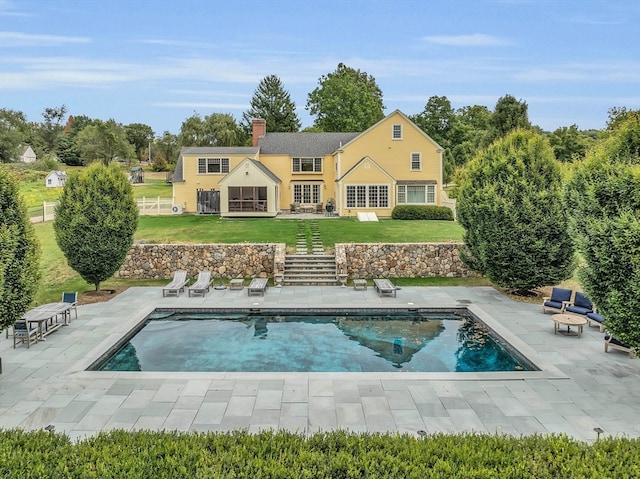 rear view of property with a yard and a patio