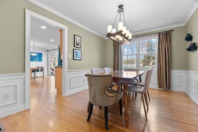 dining space featuring ornamental molding, a chandelier, and a healthy amount of sunlight