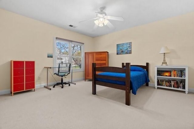 carpeted bedroom featuring a ceiling fan, baseboards, and visible vents