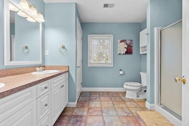 full bath with visible vents, a sink, baseboards, and a shower stall