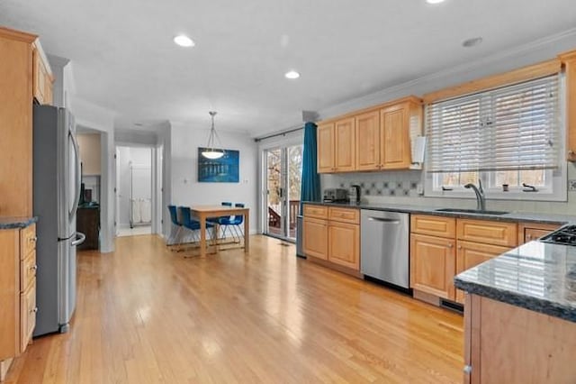 kitchen featuring a sink, light brown cabinetry, light wood-style floors, and stainless steel appliances