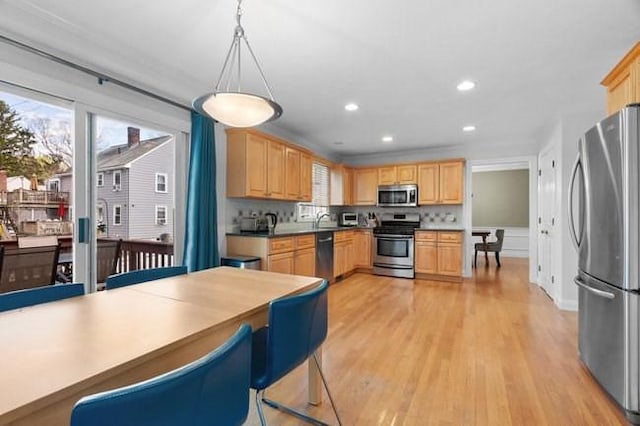 kitchen featuring light brown cabinetry, recessed lighting, appliances with stainless steel finishes, and light wood-type flooring