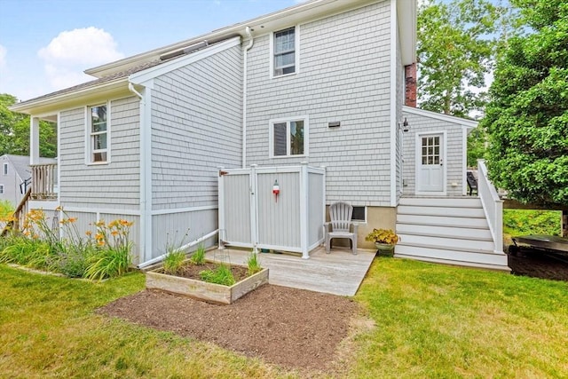 37 Berkeley Dr, Falmouth, MA 02536 - rear view of property with a yard, a garden, and a wooden deck