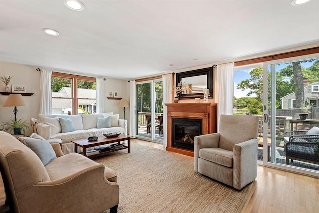 37 Berkeley Dr, Falmouth, MA 02536 - living room featuring wood finished floors, plenty of natural light, a glass covered fireplace, and recessed lighting