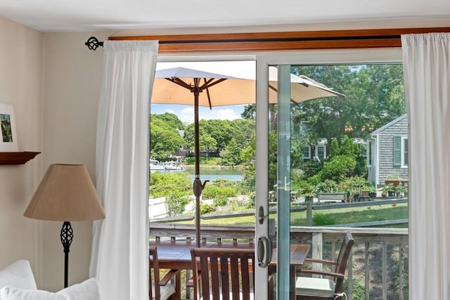 37 Berkeley Dr, Falmouth, MA 02536 - doorway featuring a water view, healthy amount of natural light, and view of wooded area