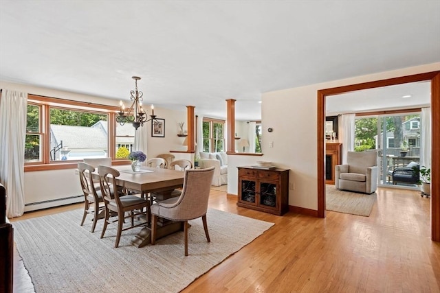 37 Berkeley Dr, Falmouth, MA 02536 - dining area with baseboard heating, a chandelier, light wood-style flooring, and a fireplace