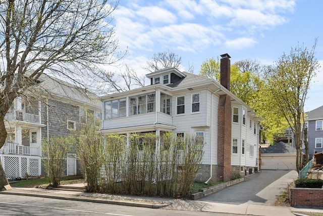 708 Belmont St Unit 708, Watertown, MA 02472 - view of front of home with a chimney and a sunroom