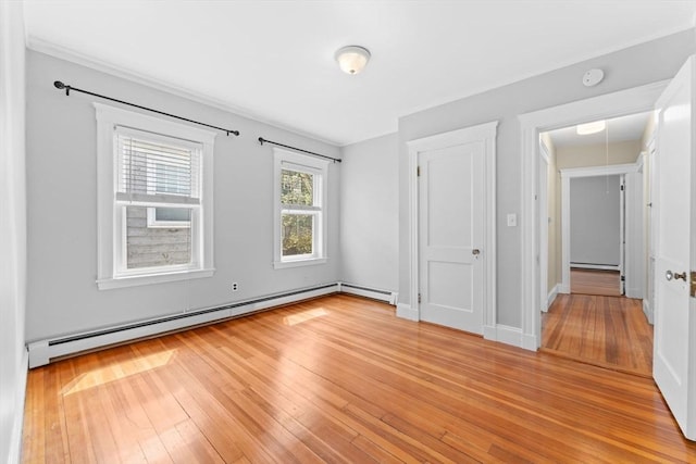 708 Belmont St Unit 708, Watertown, MA 02472 - unfurnished bedroom featuring light wood-style floors, a baseboard heating unit, and baseboard heating