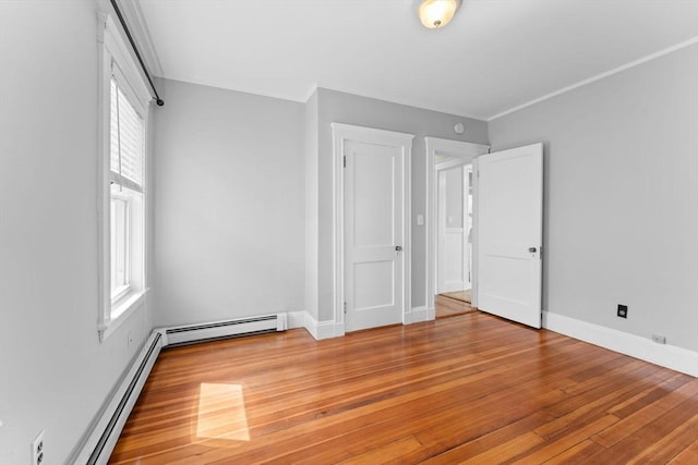 708 Belmont St Unit 708, Watertown, MA 02472 - unfurnished bedroom with light wood-style floors, multiple windows, and baseboard heating