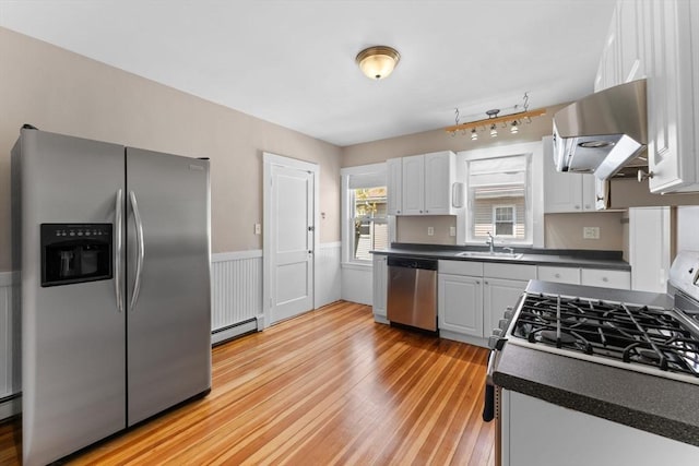708 Belmont St Unit 708, Watertown, MA 02472 - kitchen featuring dark countertops, range hood, stainless steel appliances, and light wood finished floors