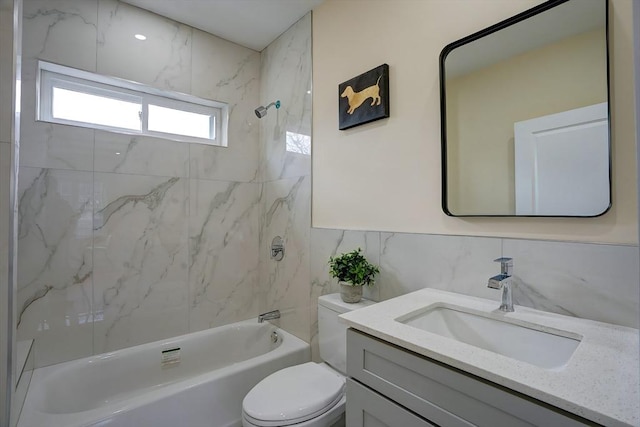 full bathroom with tub / shower combination, toilet, tile walls, and vanity