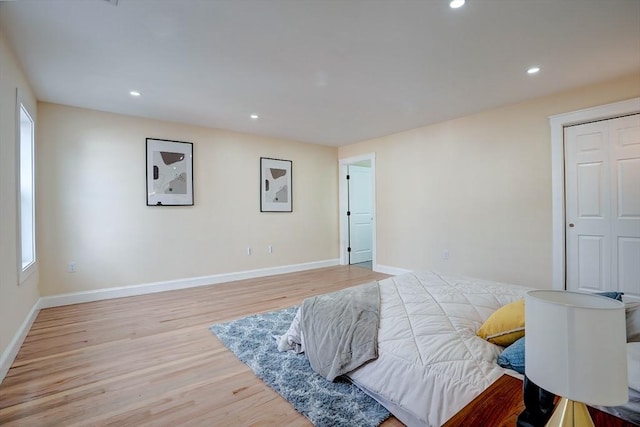 bedroom with recessed lighting, light wood-type flooring, and baseboards