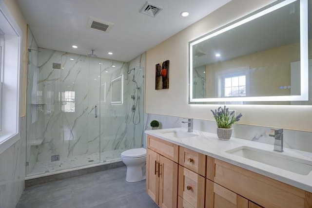 full bathroom featuring a sink, visible vents, and toilet