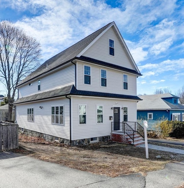 view of front of property featuring fence