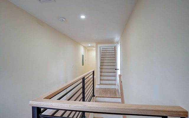 stairway featuring recessed lighting and wood finished floors