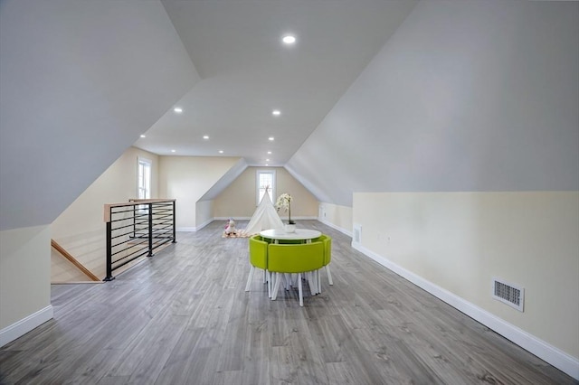 bonus room with wood finished floors, visible vents, baseboards, lofted ceiling, and recessed lighting