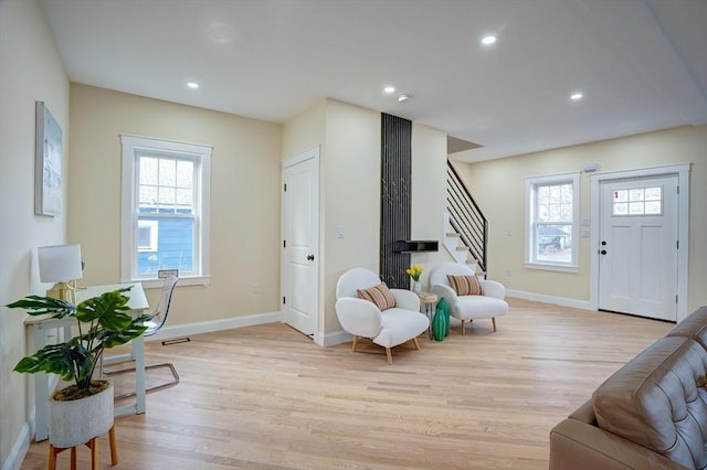 foyer entrance with visible vents, baseboards, stairway, recessed lighting, and light wood-style flooring