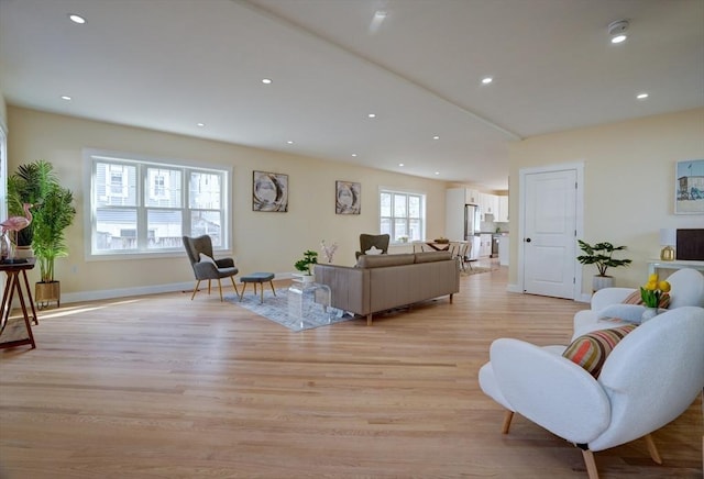 living room with light wood-style flooring, recessed lighting, and baseboards