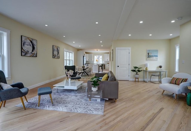 living room with light wood-style flooring, recessed lighting, and baseboards