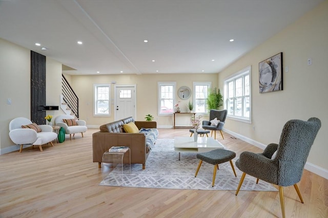 living room featuring recessed lighting, stairway, baseboards, and wood finished floors