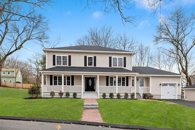 view of front of property with a garage, covered porch, and driveway