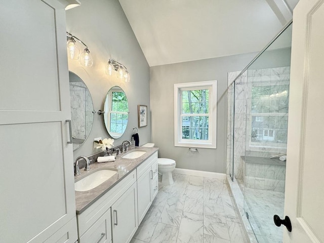 bathroom featuring marble finish floors, a shower stall, vaulted ceiling, double vanity, and toilet