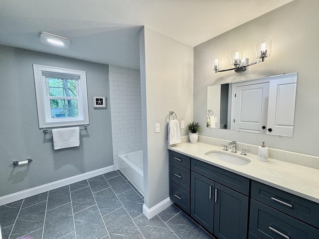 full bath with vanity and baseboards