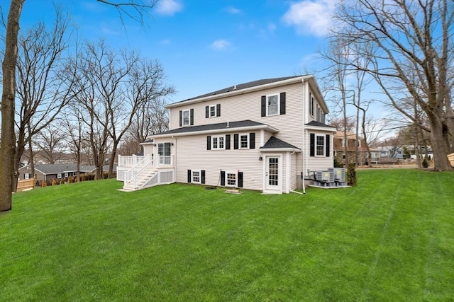 rear view of house with stairs, a yard, a deck, and central AC unit