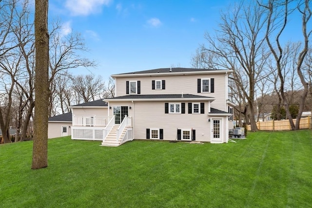 rear view of house featuring stairway and a deck