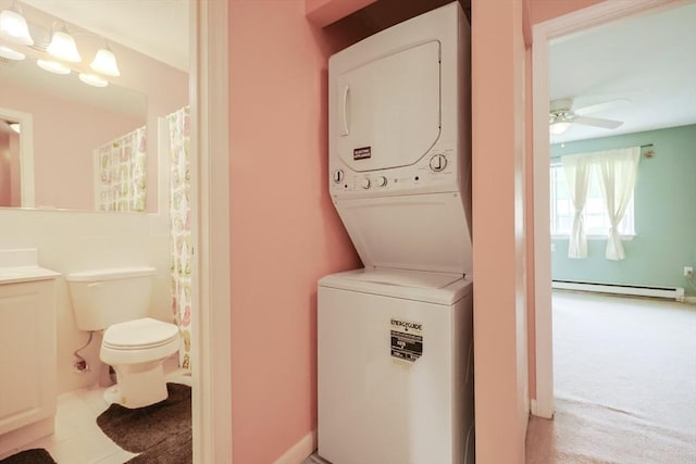 6 Janet Rd Unit 10, Easton, MA 02375 - laundry area featuring stacked washing machine and dryer, baseboard heating, ceiling fan, and light tile patterned flooring