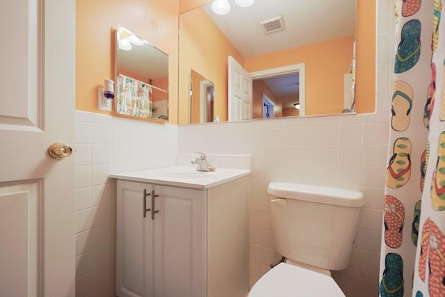 6 Janet Rd Unit 10, Easton, MA 02375 - bathroom featuring tile walls, toilet, vanity, wainscoting, and a shower with shower curtain