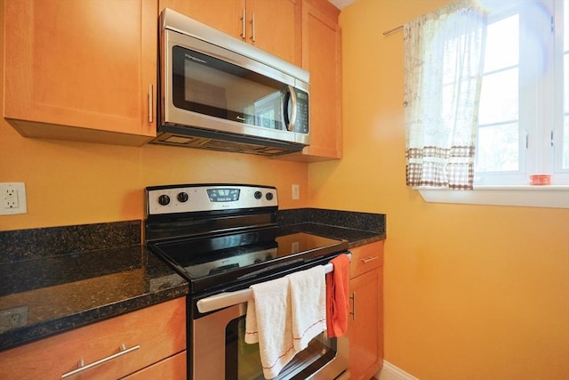 6 Janet Rd Unit 10, Easton, MA 02375 - kitchen with appliances with stainless steel finishes, dark stone counters, and baseboards