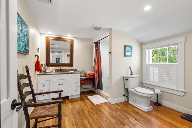 bathroom with vanity, baseboards, a shower with curtain, and wood finished floors
