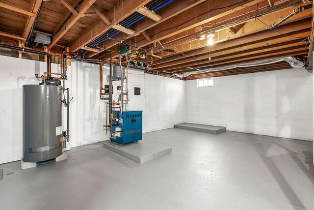 below grade area featuring a heating unit and water heater