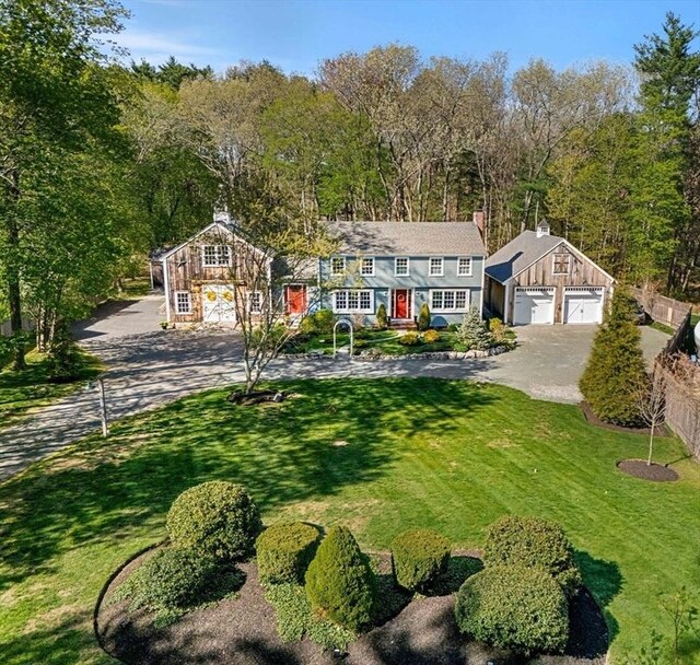view of front of property featuring a detached garage, an outbuilding, and a front yard