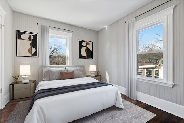 bedroom with dark hardwood / wood-style floors