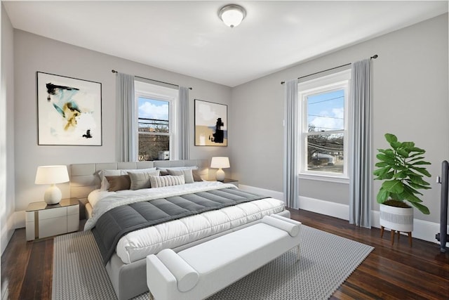 bedroom with dark hardwood / wood-style flooring