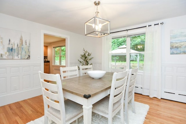 23 Green Lodge St, Canton, MA 02021 - dining space featuring a chandelier, a wainscoted wall, light wood-type flooring, a baseboard heating unit, and a decorative wall