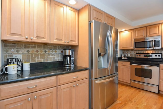 23 Green Lodge St, Canton, MA 02021 - kitchen with appliances with stainless steel finishes, tasteful backsplash, light wood-style floors, recessed lighting, and dark stone countertops