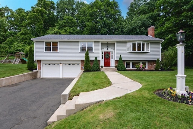 23 Green Lodge St, Canton, MA 02021 - split foyer home with asphalt driveway, a garage, a chimney, and a front lawn