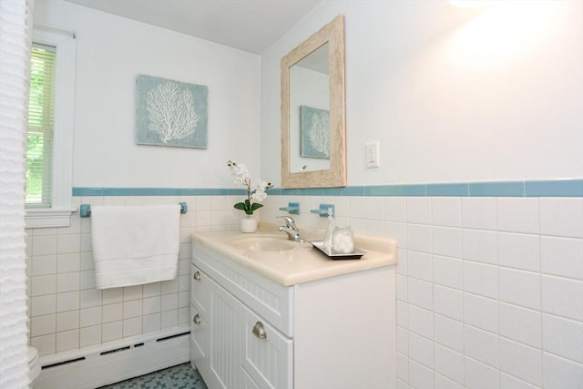 23 Green Lodge St, Canton, MA 02021 - bathroom featuring a baseboard heating unit, vanity, tile walls, wainscoting, and toilet