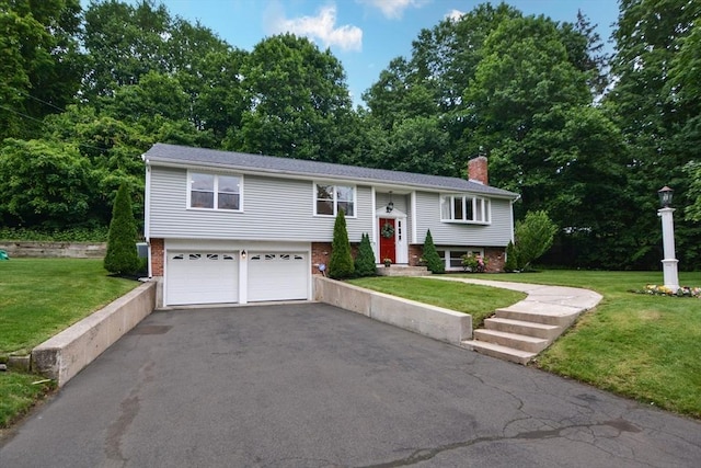 23 Green Lodge St, Canton, MA 02021 - bi-level home featuring a chimney, a garage, brick siding, driveway, and a front lawn