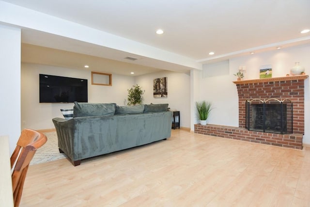 23 Green Lodge St, Canton, MA 02021 - living room with wood finished floors, recessed lighting, and a brick fireplace