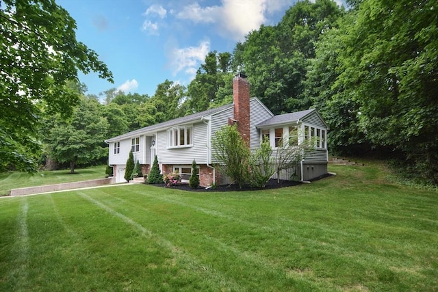 23 Green Lodge St, Canton, MA 02021 - raised ranch featuring a chimney, a sunroom, a front yard, and an attached garage