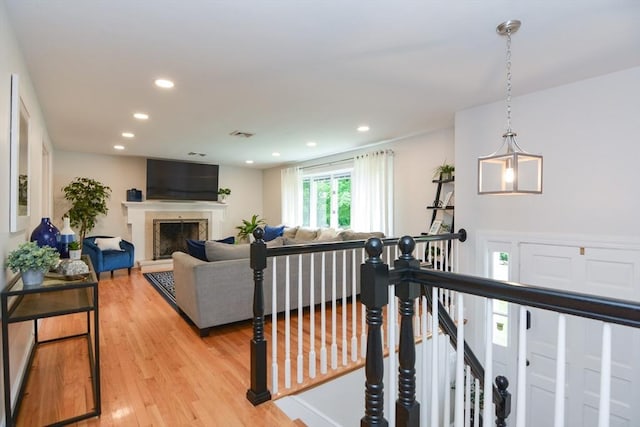 23 Green Lodge St, Canton, MA 02021 - living area featuring light wood-type flooring, recessed lighting, and a fireplace with raised hearth
