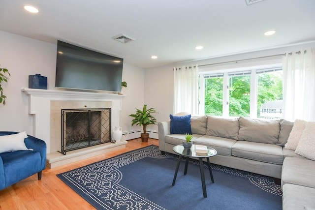 23 Green Lodge St, Canton, MA 02021 - living room featuring a baseboard heating unit, wood finished floors, recessed lighting, and a tiled fireplace